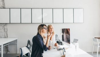 blonde-woman-glasses-black-shirt-working-table-with-computer-documents-it (1)